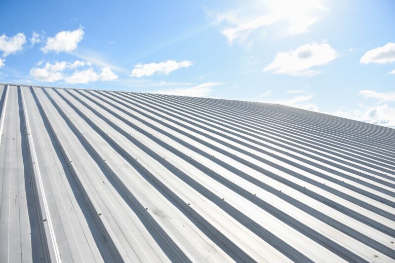 Metal,Sheet,Roofing,On,Commercial,Construction,With,Blue,Sky